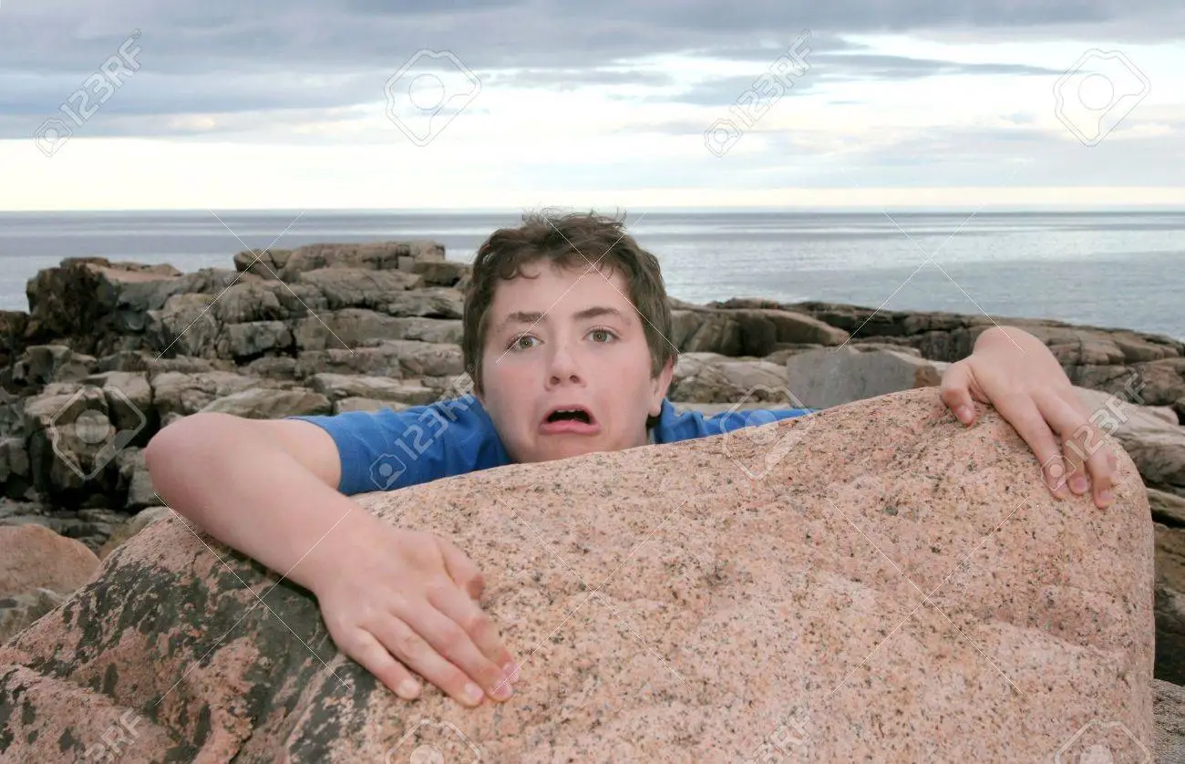 3854465-a-young-boy-child-falling-off-a-rock-on-the-coast
