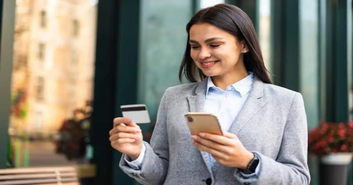 smiley-businesswoman-using-smartphone-credit-card-outdoors-23-2148767012-1-_1200x630xt.jpg