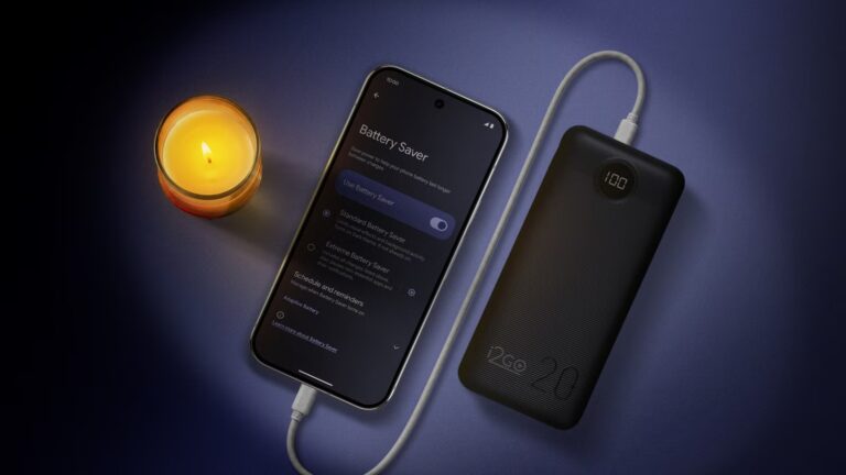 a-phone-in-battery-saver-mode-charges-from-a-power-bank-beside-a-candle.jpg