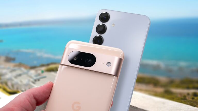 a-google-pixel-8-held-in-front-of-a-samsung-galaxy-s25-with-a-blurred-coastal-background.jpg