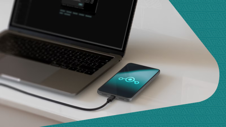 a-smartphone-displaying-the-lineageos-logo-connected-to-a-laptop-via-usb-cable.png